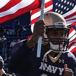 Navy football players with U.S. Flag